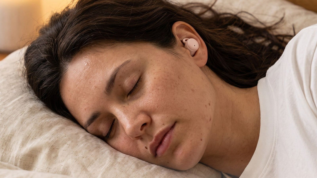 Woman asleep on her side wearing a ViSound Hush sleep earbud