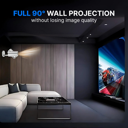 A modern home cinema room with a white sectional sofa and black marble coffee table features a silver wall-mounted projector casting a vibrant orange racing car on a track with blue sky onto the wall, showcasing full 90 degree wall projection without losing image quality