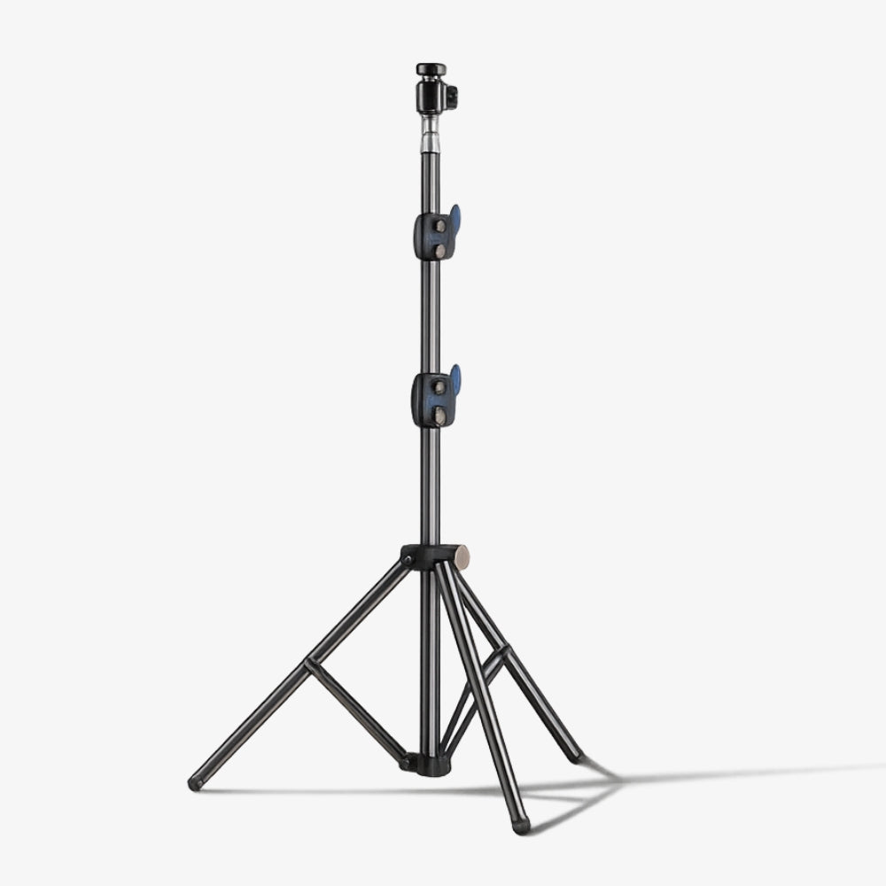 Product photography of a professional dark grey light stand featuring a telescopic center column, two vibrant blue quick-release adjustment levers, and a stable three-legged tripod base isolated on a clean white studio background