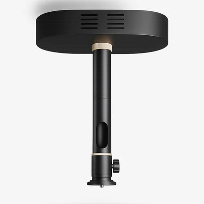 Photograph of a sleek matte black ceiling mount featuring an oval plate with horizontal grooved slits, a central cylindrical pole with two cream rings, an elongated vertical cutout, and a side adjustment knob